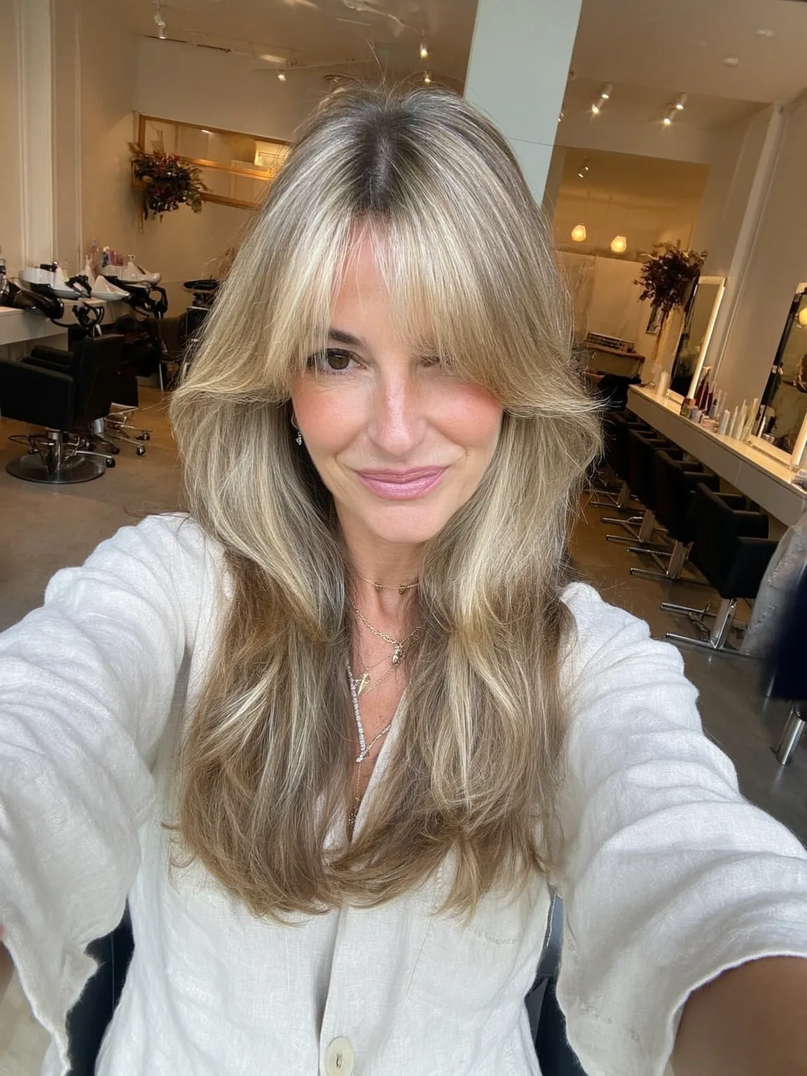 Oval Face Wavy Layers with Ash Blonde Curtain Bangs